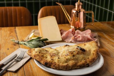 calzone relleno de crema de parmesano, paleta de cerdo cocida, mantequilla y salvia